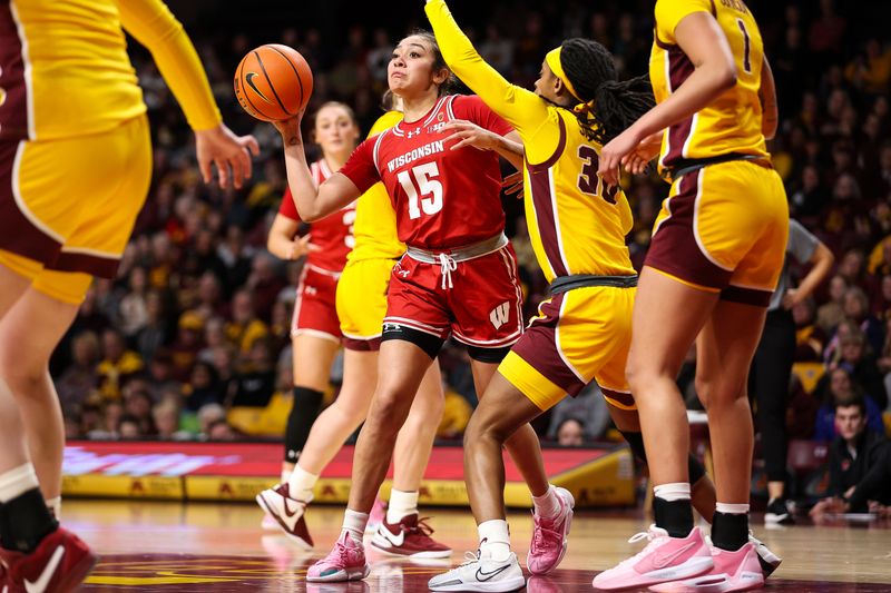 Feb 20, 2024; Minneapolis, Minnesota, USA; Wisconsin Badgers guard Sania Copeland (15) passes as Minnesota Golden Gophers guard Janay Sanders (30) during the second half at Williams Arena. Mandatory Credit: Matt Krohn-USA TODAY Sports