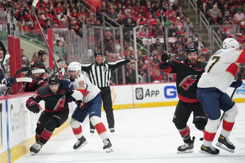 May 20, 2025; Raleigh, North Carolina, USA; Florida Panthers forward Evan Rodrigues (17) checks Carolina Hurricanes defenseman Sean Walker (26) during the first periodin game one of the Eastern Conference Final of the 2025 Stanley Cup Playoffs at Lenovo Center. Mandatory Credit: James Guillory-Imagn Images