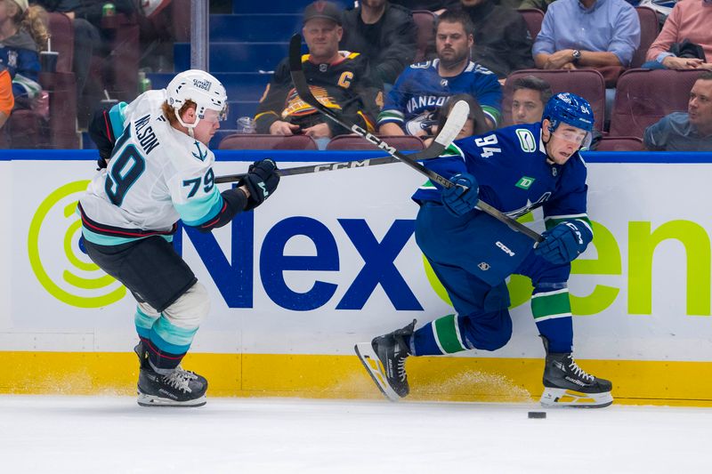 Sep 24, 2024; Vancouver, British Columbia, CAN; Seattle Kraken defenseman Ty Nelson (79) stick checks Vancouver Canucks forward Linus Karlsson (94) during the third period at Rogers Arena. Mandatory Credit: Bob Frid-Imagn Images