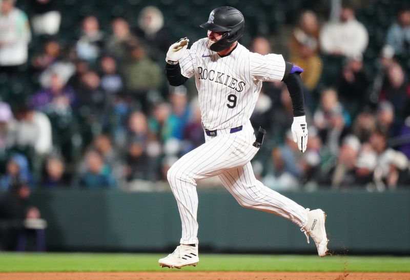 Apr 23, 2024; Denver, Colorado, USA; Colorado Rockies outfielder Brenton Doyle (9) runs out a double in the fifth inning against the San Diego Padres at Coors Field. Mandatory Credit: Ron Chenoy-USA TODAY Sports