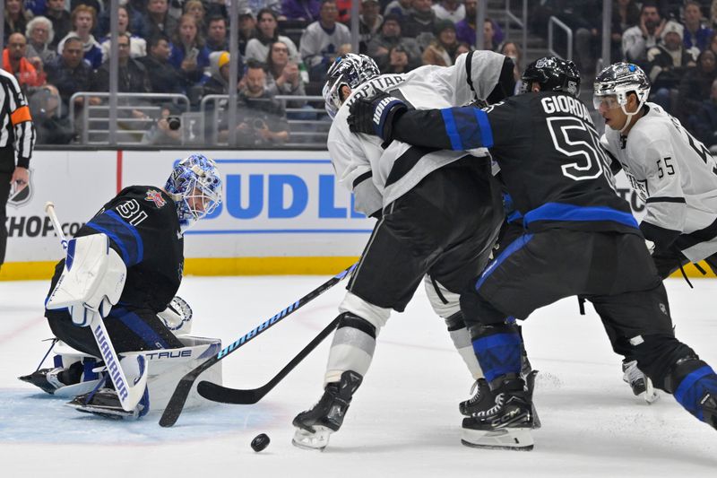 Jan 2, 2024; Los Angeles, California, USA; Toronto Maple Leafs goaltender Martin Jones (31) makes a save off a shot by Los Angeles Kings center Anze Kopitar (11) and Toronto Maple Leafs defenseman Mark Giordano (55) defends in the second period at Crypto.com Arena. Mandatory Credit: Jayne Kamin-Oncea-USA TODAY Sports