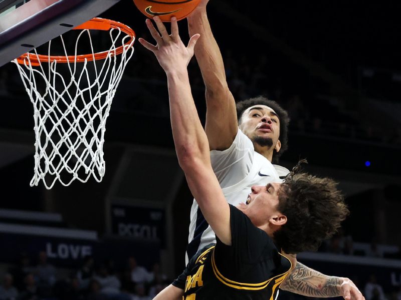 Feb 28, 2026; University Park, Pennsylvania, USA; Penn State Nittany Lions guard Freddie Dilione V (5) blocks a shot attempted by Iowa Hawkeyes guard Isaia Howard (23) during the second half at Bryce Jordan Center. Mandatory Credit: Matthew O'Haren-Imagn Images