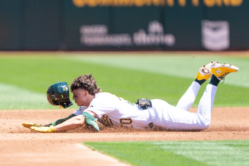 Aug 6, 2023; Oakland, California, USA;  Oakland Athletics second baseman Zack Gelof (20) slides during the first inning against the San Francisco Giants at Oakland-Alameda County Coliseum. Mandatory Credit: Stan Szeto-USA TODAY Sports