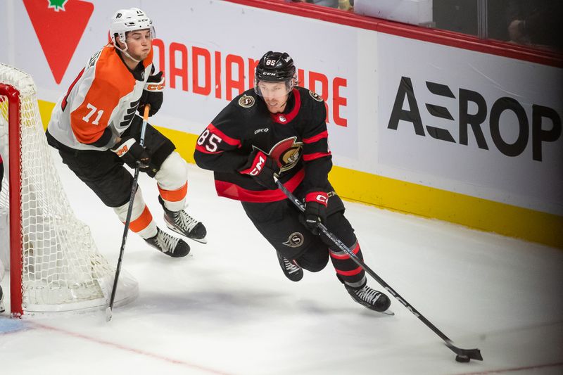 Oct 14, 2023; Ottawa, Ontario, CAN; Ottawa Senators defenseman Jake Sanderson (85) skates with the puck in front of Philadelphia Flyers right wing Tyson Foerster (71) in the third period at the Canadian Tire Centre. Mandatory Credit: Marc DesRosiers-USA TODAY Sports