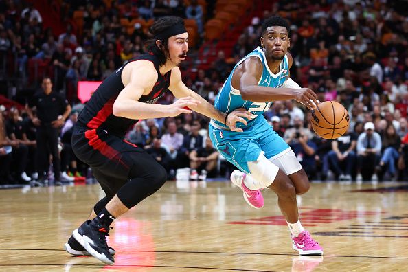 MIAMI, FLORIDA - DECEMBER 13: Brandon Miller #24 of the Charlotte Hornets drives against Jaime Jaquez Jr. #11 of the Miami Heat during the third quarter of the game at Kaseya Center on December 13, 2023 in Miami, Florida. NOTE TO USER: User expressly acknowledges and agrees that, by downloading and or using this photograph, User is consenting to the terms and conditions of the Getty Images License Agreement. (Photo by Megan Briggs/Getty Images)