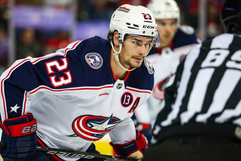 Dec 3, 2024; Calgary, Alberta, CAN; Columbus Blue Jackets center Sean Monahan (23) during the face off against the Calgary Flames during the second period at Scotiabank Saddledome. Mandatory Credit: Sergei Belski-Imagn Images