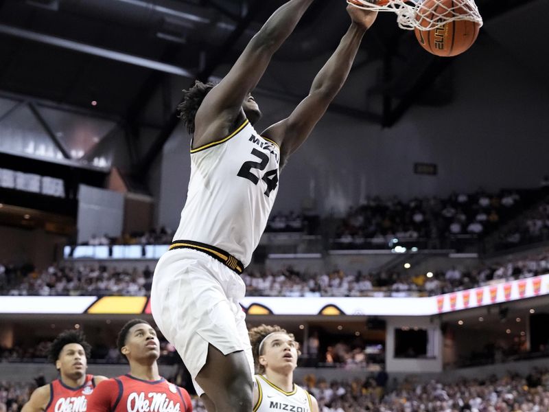 Mar 4, 2023; Columbia, Missouri, USA; Missouri Tigers guard Kobe Brown (24) dunks the ball as Mississippi Rebels guard Matthew Murrell (11) looks on during the first half at Mizzou Arena. Mandatory Credit: Denny Medley-USA TODAY Sports