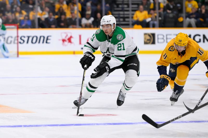 Oct 10, 2024; Nashville, Tennessee, USA; Dallas Stars left wing Jason Robertson (21) skates as Nashville Predators center Colton Sissons (10) chases during the second period at Bridgestone Arena. Mandatory Credit: Steve Roberts-Imagn Images