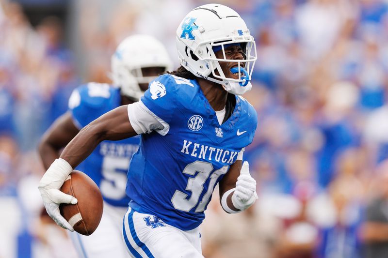 Sep 9, 2023; Lexington, Kentucky, USA; Kentucky Wildcats defensive back Maxwell Hairston (31) celebrates an interception during the second quarter against the Eastern Kentucky Colonels at Kroger Field. Mandatory Credit: Jordan Prather-USA TODAY Sports