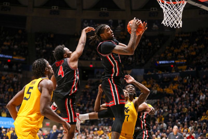 Jan 29, 2025; Morgantown, West Virginia, USA; Houston Cougars forward Ja'Vier Francis (5) grabs a rebound during the second half against the West Virginia Mountaineers at WVU Coliseum. Mandatory Credit: Ben Queen-Imagn Images