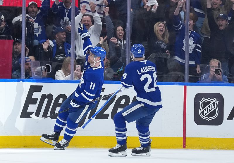 May 7, 2025; Toronto, Ontario, CAN; Toronto Maple Leafs center Max Domi (11) scores a goal and celebrates with left wing Scott Laughton (24) against the Florida Panthers during the second period in game two of the second round of the 2025 Stanley Cup Playoffs at Scotiabank Arena. Mandatory Credit: Nick Turchiaro-Imagn Images