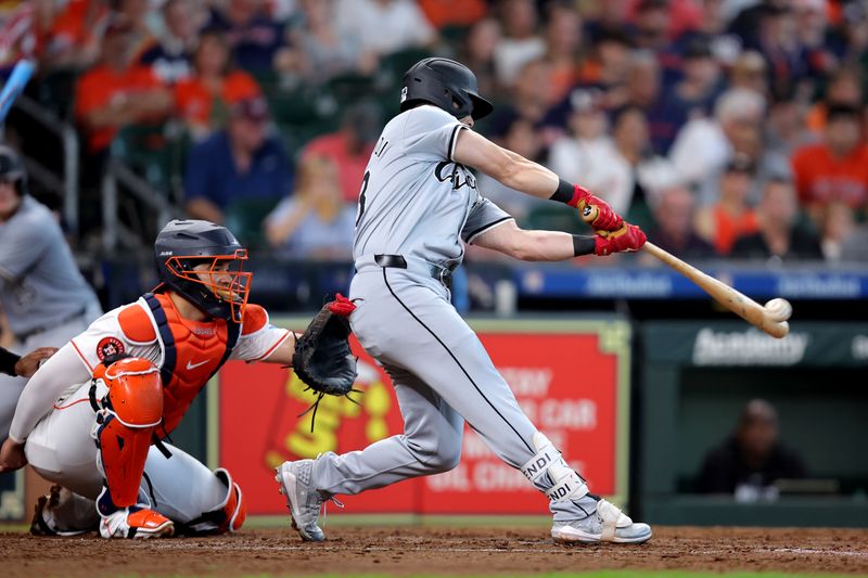 Aug 18, 2024; Houston, Texas, USA; Chicago White Sox designated hitter Andrew Benintendi (23) hits a single to right field against the Houston Astros during the seventh inning at Minute Maid Park. Mandatory Credit: Erik Williams-USA TODAY Sports
