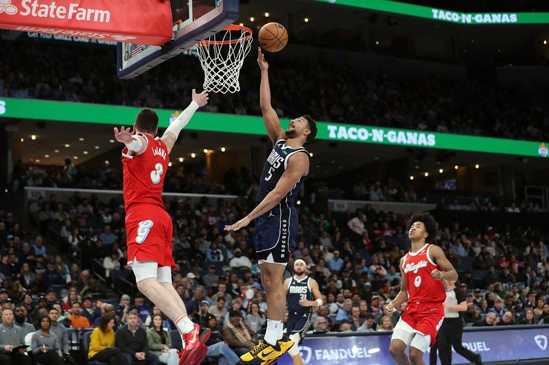 MEMPHIS, TENNESSEE - JANUARY 06: Quentin Grimes #5 of the Dallas Mavericks goes to the basket against Jake LaRavia #3 of the Memphis Grizzlies during the first half at FedExForum on January 06, 2025 in Memphis, Tennessee. NOTE TO USER: User expressly acknowledges and agrees that, by downloading and or using this photograph, User is consenting to the terms and conditions of the Getty Images License Agreement. (Photo by Justin Ford/Getty Images)