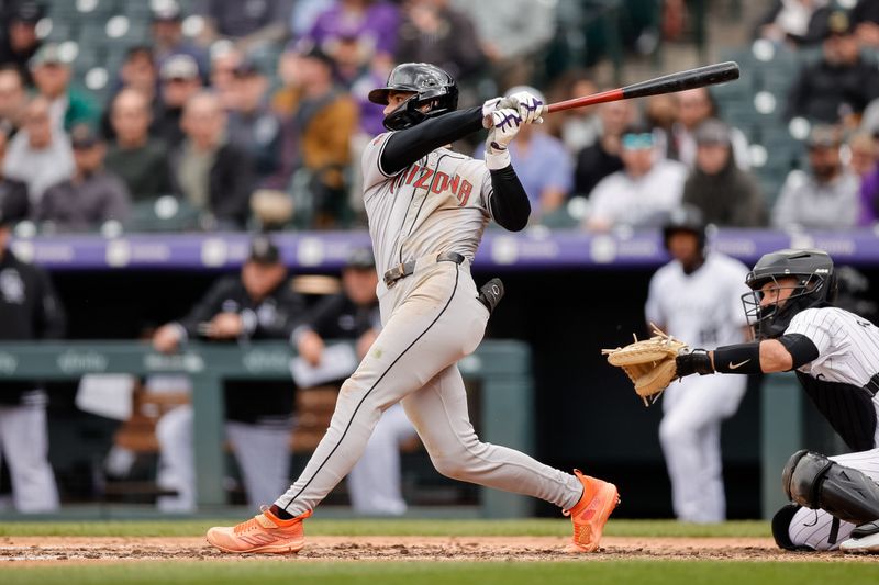 Apr 10, 2024; Denver, Colorado, USA; Arizona Diamondbacks shortstop Blaze Alexander (9) hits a single in the sixth inning against the Colorado Rockies at Coors Field. Mandatory Credit: Isaiah J. Downing-USA TODAY Sports