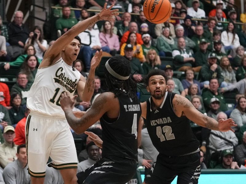 Feb 27, 2024; Fort Collins, Colorado, USA; Colorado State Rams guard Nique Clifford (10) passes the ball over two Nevada Wolf Pack defenders at Moby Arena. Mandatory Credit: Michael Madrid-USA TODAY Sports