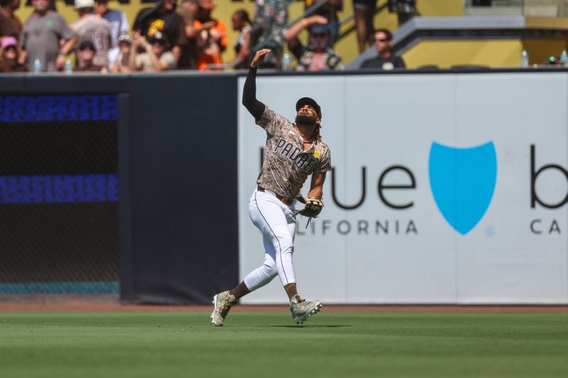 Sep 8, 2024; San Diego, California, USA; San Diego Padres right fielder Fernando Tatis Jr. (23) loses a fly ball in the sun resulting in a double to San Francisco Giants center fielder Heliot Ramos (17) during the fourth inning at Petco Park. Mandatory Credit: Chadd Cady-Imagn Images