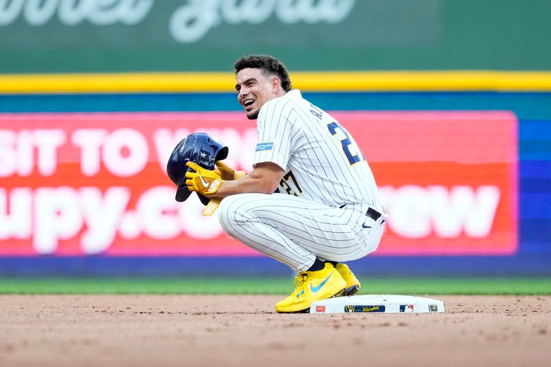 Jul 27, 2024; Milwaukee, Wisconsin, USA;  Milwaukee Brewers shortstop Willy Adames (27) enjoys a moment at second base during the fourth inning against the Miami Marlins at American Family Field. Mandatory Credit: Jeff Hanisch-USA TODAY Sports