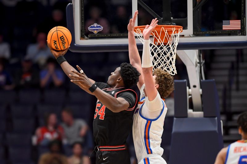 Mar 14, 2024; Nashville, TN, USA;  Georgia Bulldogs center Russel Tchewa (54) shoots over Florida Gators forward Thomas Haugh (10) during the second half at Bridgestone Arena. Mandatory Credit: Steve Roberts-USA TODAY Sports