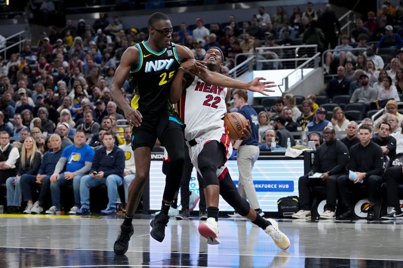 INDIANAPOLIS, INDIANA - APRIL 07: Jimmy Butler #22 of the Miami Heat dribbles the ball while being guarded by Jalen Smith #25 of the Indiana Pacers in the second quarter at Gainbridge Fieldhouse on April 07, 2024 in Indianapolis, Indiana. NOTE TO USER: User expressly acknowledges and agrees that, by downloading and or using this photograph, User is consenting to the terms and conditions of the Getty Images License Agreement. (Photo by Dylan Buell/Getty Images)