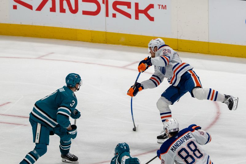 Feb 28, 2026; San Jose, California, USA; Edmonton Oilers center Jack Roslovic (28) shoots the puck while being defended by San Jose Sharks defenseman John Klingberg (3) during the third period at SAP Center at San Jose. Mandatory Credit: Neville E. Guard-Imagn Images