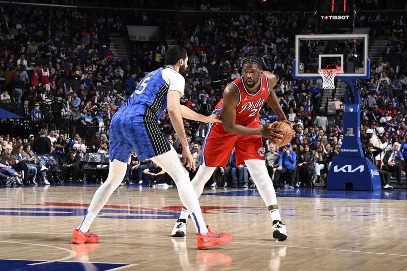 PHILADELPHIA, PA - APRIL 12: Joel Embiid #21 of the Philadelphia 76ers looks to pass the ball during the game against the Orlando Magic on April 12, 2024 at the Wells Fargo Center in Philadelphia, Pennsylvania NOTE TO USER: User expressly acknowledges and agrees that, by downloading and/or using this Photograph, user is consenting to the terms and conditions of the Getty Images License Agreement. Mandatory Copyright Notice: Copyright 2024 NBAE (Photo by David Dow/NBAE via Getty Images)