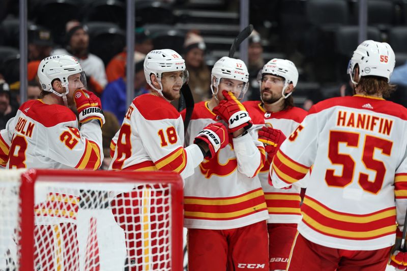 Dec 21, 2023; Anaheim, California, USA;  Calgary Flames left wing A.J. Greer (18) celebrates with teammates after scoring an empty net goal during the third period against the Anaheim Ducks at Honda Center. Mandatory Credit: Kiyoshi Mio-USA TODAY Sports