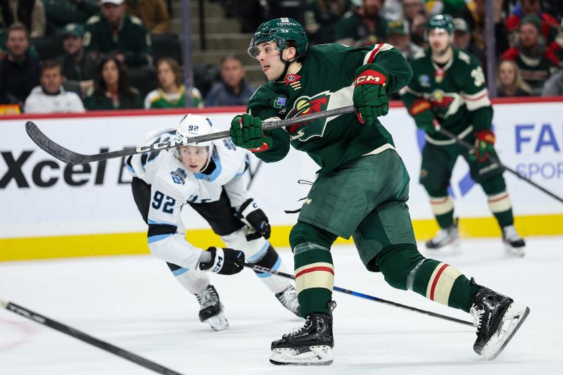 Jan 23, 2025; Saint Paul, Minnesota, USA; Minnesota Wild defenseman Brock Faber (7) shoots as Utah Hockey Club center Logan Cooley (92) defends during the second period at Xcel Energy Center. Mandatory Credit: Matt Krohn-Imagn Images