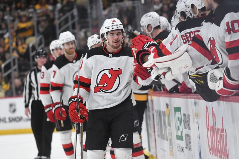 Nov 16, 2023; Pittsburgh, Pennsylvania, USA; New Jersey Devils right wing Alexander Holtz (10) is greeted by his teammates after scoring a goal against the Pittsburgh Penguins during the third period at PPG Paints Arena. Mandatory Credit: Philip G. Pavely-USA TODAY Sports