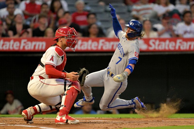 Sep 23, 2025; Anaheim, California, USA;  Kansas City Royals shortstop Bobby Witt Jr. (7) beats the throw to Los Angeles Angels catcher Logan O'Hoppe (14) as he scored on a single by catcher Salvador Perez (13) during the first inning at Angel Stadium. Mandatory Credit: Jayne Kamin-Oncea-Imagn Images