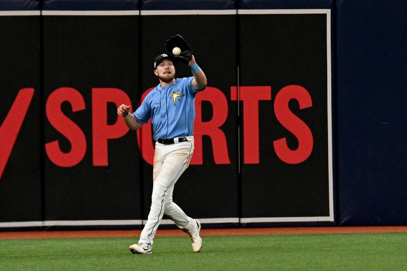 Sep 10, 2023; St. Petersburg, Florida, USA; Tampa Bay Rays left fielder Luke Raley (55) catches a line drive in the sixth inning against the Seattle Mariners at Tropicana Field. Mandatory Credit: Jonathan Dyer-USA TODAY Sports