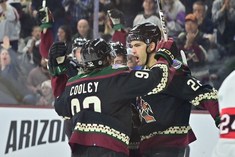 Dec 19, 2023; Tempe, Arizona, USA; Arizona Coyotes center Jack McBain (22) celebrates with center Logan Cooley (92) after scoring a goal in the second period against the Ottawa Senators at Mullett Arena. Mandatory Credit: Matt Kartozian-USA TODAY Sports