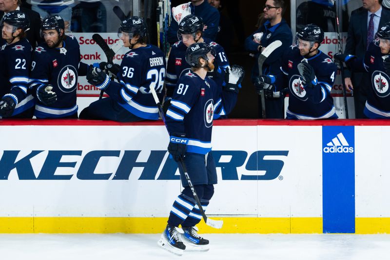 Jan 16, 2024; Winnipeg, Manitoba, CAN; Winnipeg Jets forward Kyle Connor (81) is congratulated by his teammates on his goal against the New York Islanders during the third period at Canada Life Centre. Mandatory Credit: Terrence Lee-USA TODAY Sports