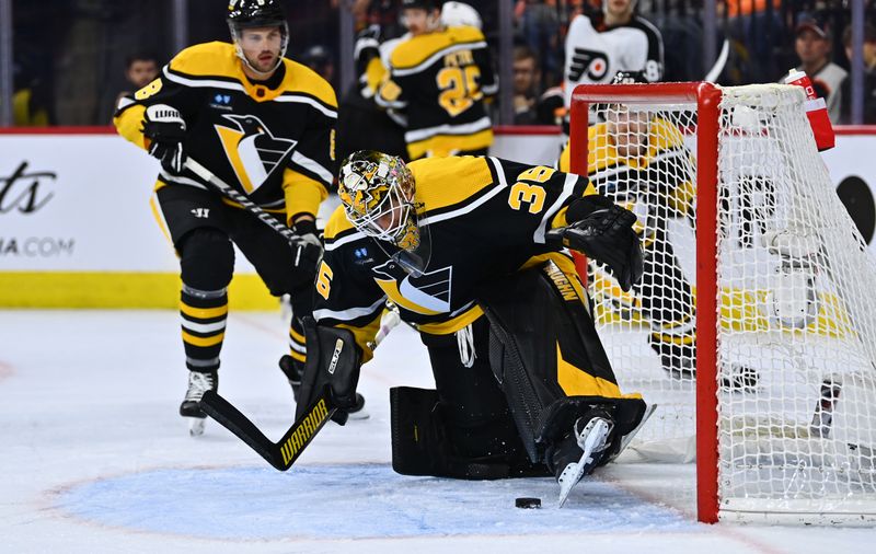 Nov 25, 2022; Philadelphia, Pennsylvania, USA; Pittsburgh Penguins goalie Tristan Jarry (35) jumps to cover up the puck against the Philadelphia Flyers in the third period at Wells Fargo Center. Mandatory Credit: Kyle Ross-USA TODAY Sports