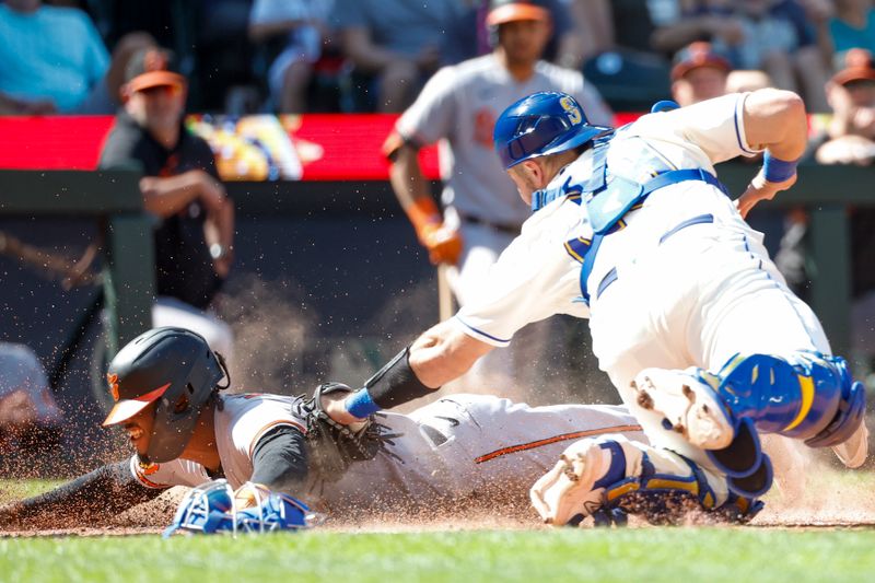 Aug 13, 2023; Seattle, Washington, USA; Baltimore Orioles pinch runner Jorge Mateo (3) avoids a tag by Seattle Mariners catcher Cal Raleigh (29) to score a run during the ninth inning at T-Mobile Park. Mandatory Credit: Joe Nicholson-USA TODAY Sports