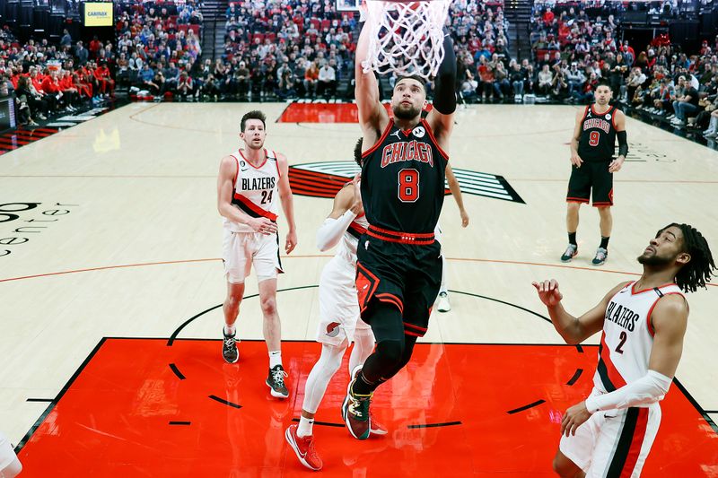 PORTLAND, OREGON - MARCH 24: Zach LaVine #8 of the Chicago Bulls dunks the ball as Trendon Watford #2 of the Portland Trail Blazers looks on during the second half at Moda Center on March 24, 2023 in Portland, Oregon. NOTE TO USER: User expressly acknowledges and agrees that, by downloading and or using this photograph, User is consenting to the terms and conditions of the Getty Images License Agreement. (Photo by Soobum Im/Getty Images)