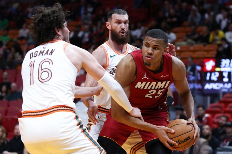 MIAMI, FLORIDA - FEBRUARY 07: Orlando Robinson #25 of the Miami Heat rebounds the ball against Cedi Osman #16 of the San Antonio Spurs during the fourth quarter of the game at Kaseya Center on February 07, 2024 in Miami, Florida. NOTE TO USER: User expressly acknowledges and agrees that, by downloading and or using this photograph, User is consenting to the terms and conditions of the Getty Images License Agreement. (Photo by Megan Briggs/Getty Images)