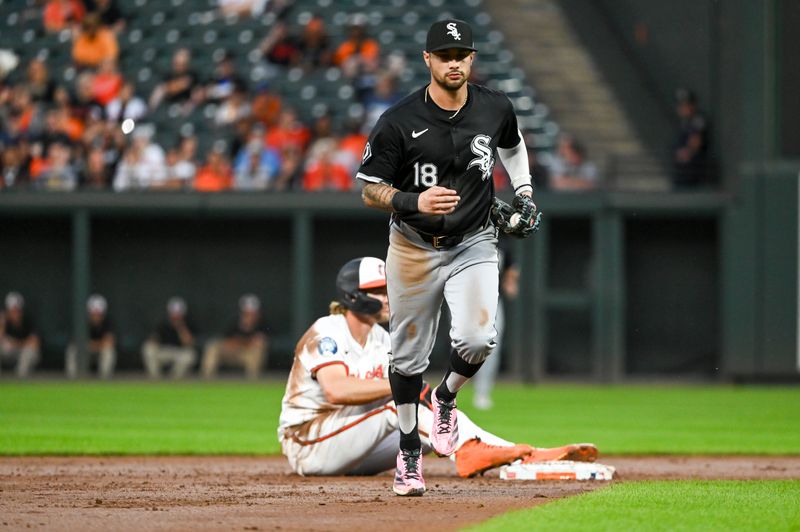 Sep 4, 2024; Baltimore, Maryland, USA; Chicago White Sox second base Jacob Amaya (18) runs to the dugout ofter catching Baltimore Orioles shortstop Gunnar Henderson (2) stealing to end the third inning  at Oriole Park at Camden Yards. Mandatory Credit: Tommy Gilligan -Imagn Images