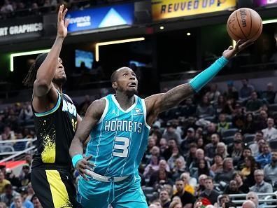 INDIANAPOLIS, INDIANA - DECEMBER 20: Terry Rozier #3 of the Charlotte Hornets attempts a shot while being guarded by Myles Turner #33 of the Indiana Pacers in the third quarter at Gainbridge Fieldhouse on December 20, 2023 in Indianapolis, Indiana. NOTE TO USER: User expressly acknowledges and agrees that, by downloading and or using this photograph, User is consenting to the terms and conditions of the Getty Images License Agreement. (Photo by Dylan Buell/Getty Images)