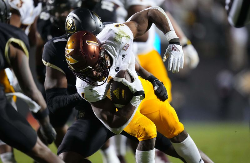 Oct 29, 2022; Boulder, Colorado, USA; Colorado Buffaloes linebacker Guy Thomas (1) tackles Arizona State Sun Devils running back Xazavian Valladay (1) in the second half at Folsom Field. Mandatory Credit: Ron Chenoy-USA TODAY Sports