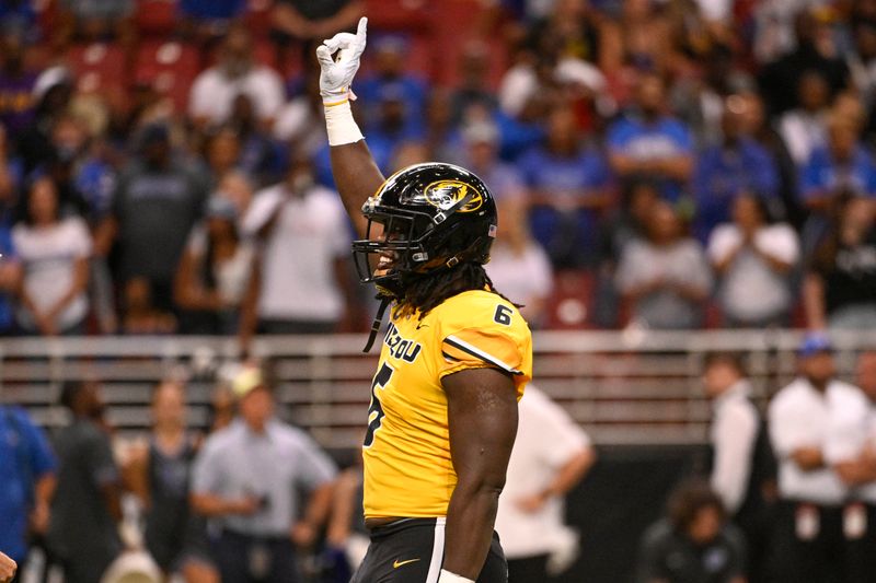 Sep 23, 2023; St. Louis, Missouri, USA; Missouri Tigers defensive lineman Darius Robinson (6) reacts after sacking Memphis Tigers quarterback Seth Henigan (2) in the first quarter at The Dome at America's Center. Mandatory Credit: Joe Puetz-USA TODAY Sports