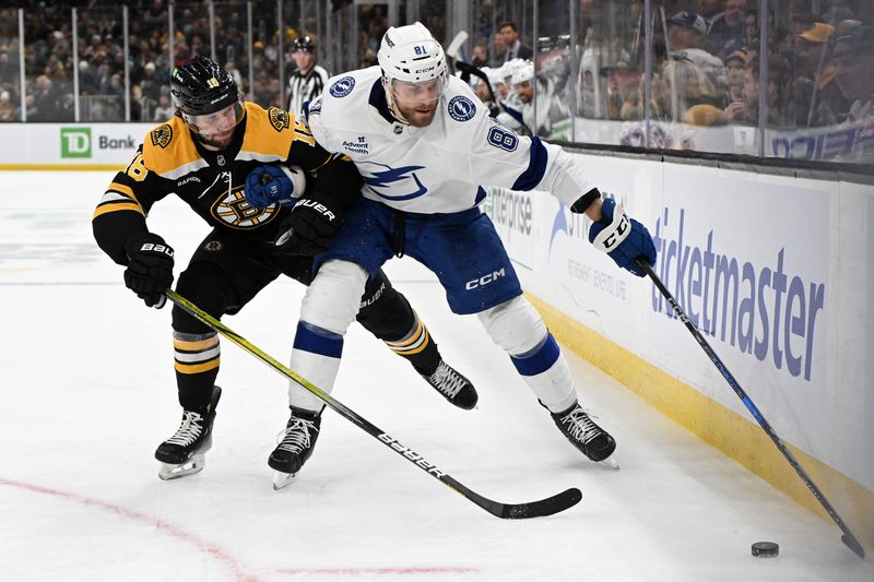 Jan 14, 2025; Boston, Massachusetts, USA; Boston Bruins center Pavel Zacha (18) and Tampa Bay Lightning defenseman Erik Cernak (81) battle for the puck during the second period at the TD Garden. Mandatory Credit: Brian Fluharty-Imagn Images