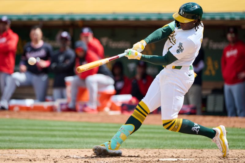 Apr 14, 2024; Oakland, California, USA; Oakland Athletics outfielder Lawrence Butler (4) hits an RBI single against the Washington Nationals  during the sixth inning at Oakland-Alameda County Coliseum. Mandatory Credit: Robert Edwards-USA TODAY Sports