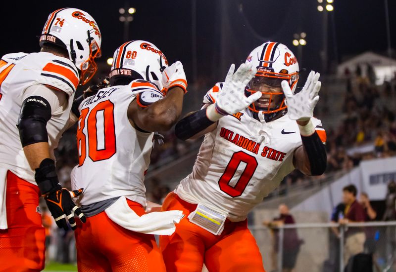 Sep 9, 2023; Tempe, Arizona, USA; Oklahoma State Cowboys wide receiver Brennan Presley (80) celebrates with running back Ollie Gordon II (0) after scoring a touchdown against the Arizona State Sun Devils in the second half at Mountain America Stadium. Mandatory Credit: Mark J. Rebilas-USA TODAY Sports