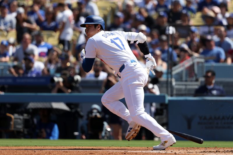 Sep 22, 2024; Los Angeles, California, USA;  Los Angeles Dodgers designated hitter Shohei Ohtani (17) hits a single during the first inning against the Colorado Rockies at Dodger Stadium. Mandatory Credit: Kiyoshi Mio-Imagn Images