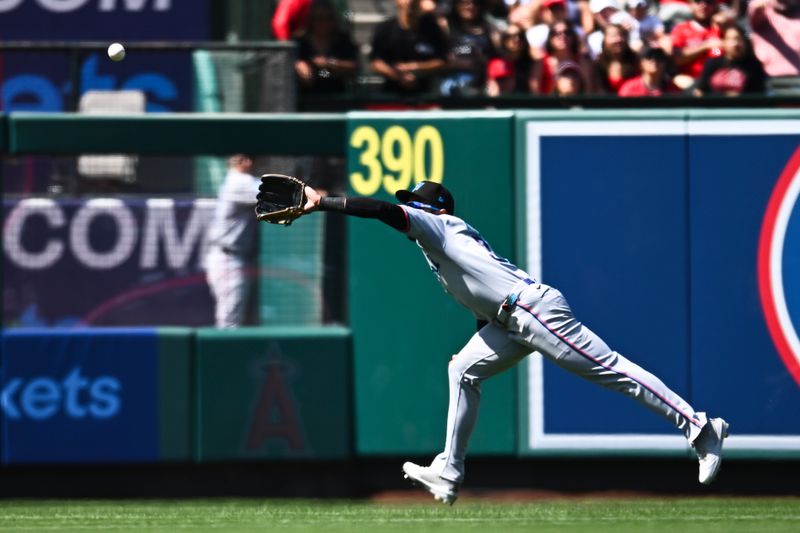 May 25, 2025; Anaheim, California, USA; Miami Marlins outfielder Derek Hill (3) makes a catch against the Los Angeles Angels during the eighth inning at Angel Stadium. Mandatory Credit: Jonathan Hui-Imagn Images