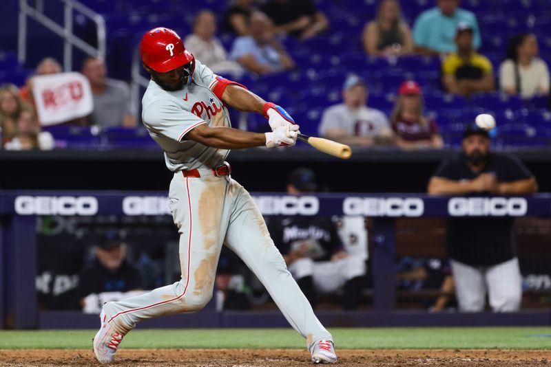 May 10, 2024; Miami, Florida, USA; Philadelphia Phillies center fielder Johan Rojas (18) hits a single against the Miami Marlins during the ninth inning at loanDepot Park. Mandatory Credit: Sam Navarro-USA TODAY Sports