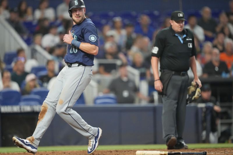 Jun 23, 2024; Miami, Florida, USA;  Seattle Mariners left fielder Luke Raley (20) scores in the seventh inning against the Miami Marlins at loanDepot Park. Mandatory Credit: Jim Rassol-USA TODAY Sports