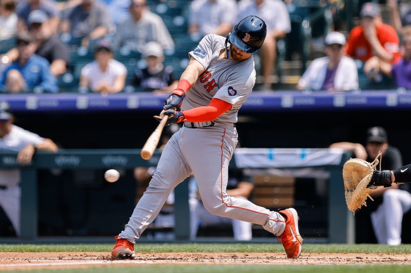 Jul 24, 2024; Denver, Colorado, USA; Boston Red Sox catcher Reese McGuire (3) hits an RBI single in the second inning against the Colorado Rockies at Coors Field. Mandatory Credit: Isaiah J. Downing-USA TODAY Sports