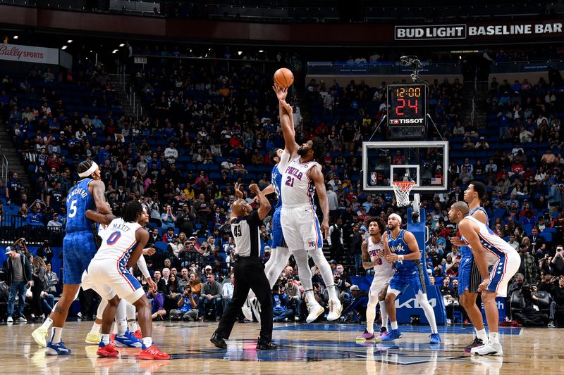 ORLANDO, FL - JANUARY 19: Joel Embiid #21 of the Philadelphia 76ers and Goga Bitadze #35 of the Orlando Magic go up for the opening tip off on January 19, 2024 at the Kia Center in Orlando, Florida. NOTE TO USER: User expressly acknowledges and agrees that, by downloading and or using this photograph, User is consenting to the terms and conditions of the Getty Images License Agreement. Mandatory Copyright Notice: Copyright 2024 NBAE (Photo by Fernando Medina/NBAE via Getty Images)