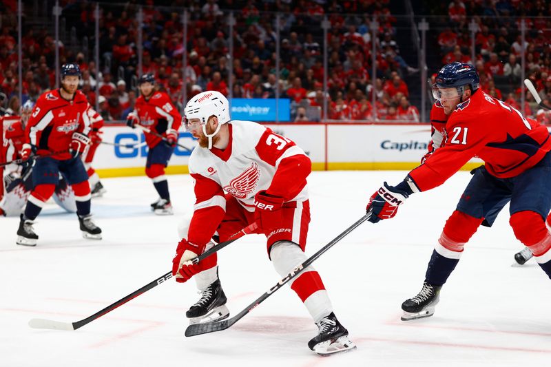 Mar 26, 2024; Washington, District of Columbia, USA; Detroit Red Wings left wing J.T. Compher (37) skates with the puck as Washington Capitals center Aliaksei Protas (21) defends during the second period at Capital One Arena. Mandatory Credit: Amber Searls-USA TODAY Sports